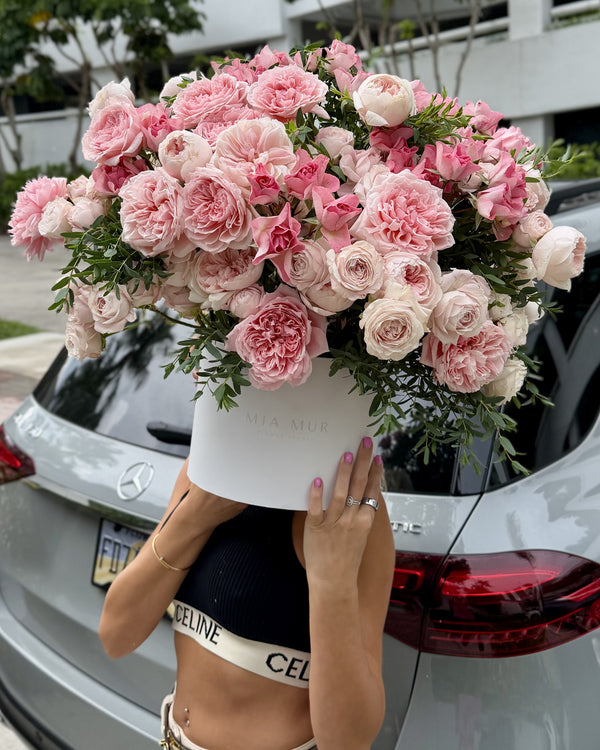 Blush peony roses in a white Mia Mur flower box, held to show its full size, Miami